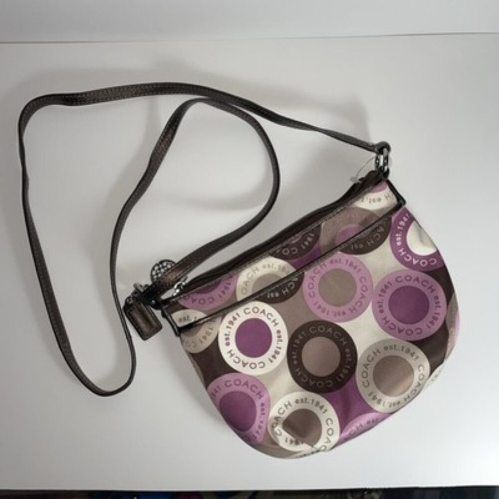 Coach crossbody bag with a purple, brown, and off-white circular "Op Art" or "S